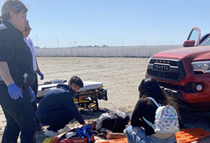 EMT teachers working with students at the beach